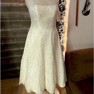Casual tea length lace strapless wedding dress with built in bustier.